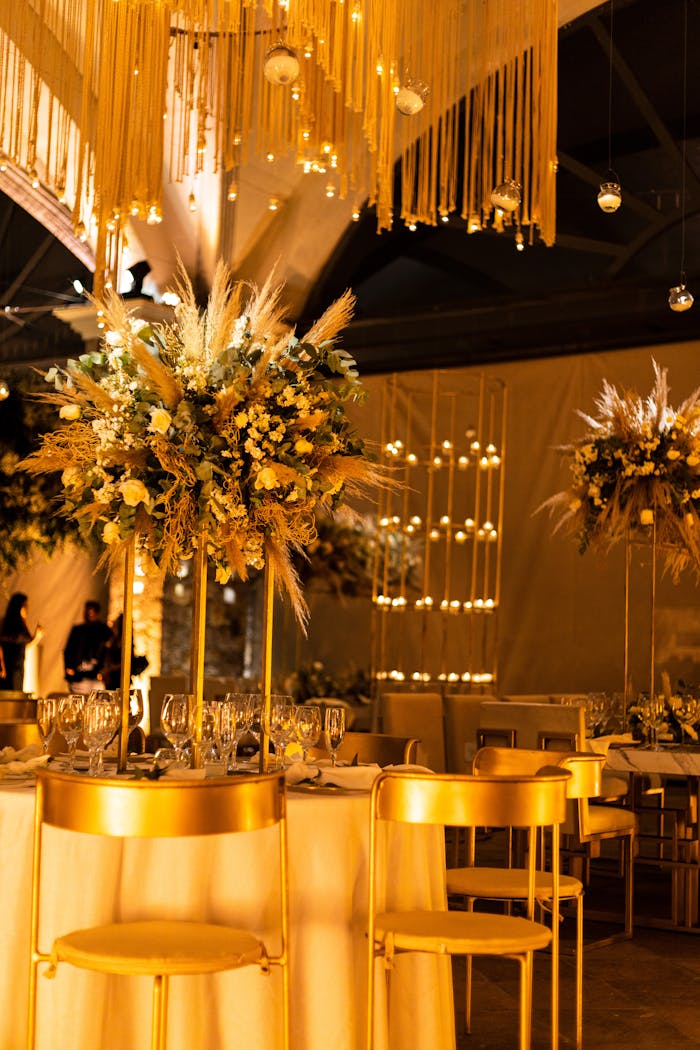 Luxurious banquet hall in San Miguel de Allende adorned with floral arrangements and golden decor.