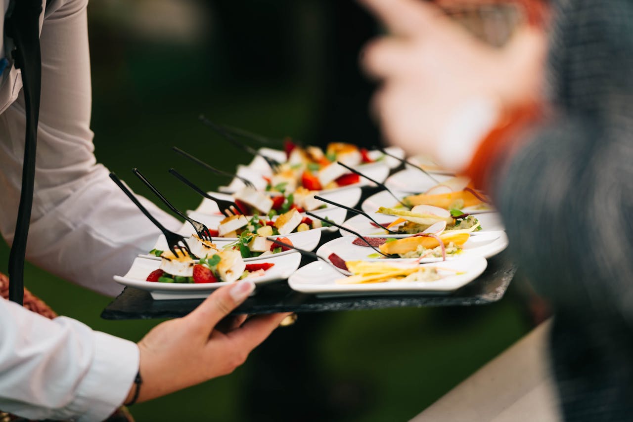 Elegant catering presentation with gourmet appetizers on a tray at a social event.